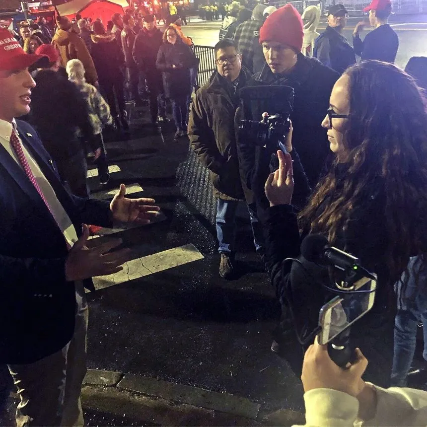 Students interview participants at political rally