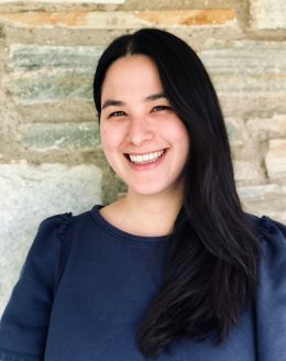 Joy Nissen headshot in front of brick wall