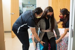 Occupational therapy students work with a client in the Activities of Daily Living (ADL) suite.