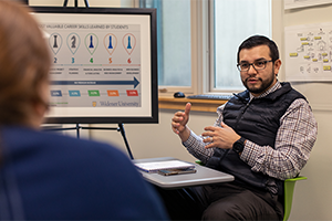 Professional sitting in Small Business Development Center working with client