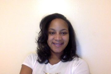 Danielle Davis headshot in front of white wall