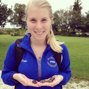 Erika Dahl holds baby turtles in her hands