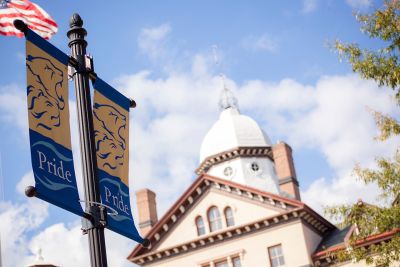 Widener Pride flags and Old Main building