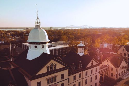 An aerial photo of Old Main shows the campus and Delaware River in the background.