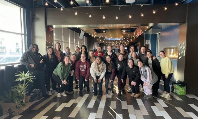 Members of the OT Doctoral class of 2026 pose in a hallway outside of a conference