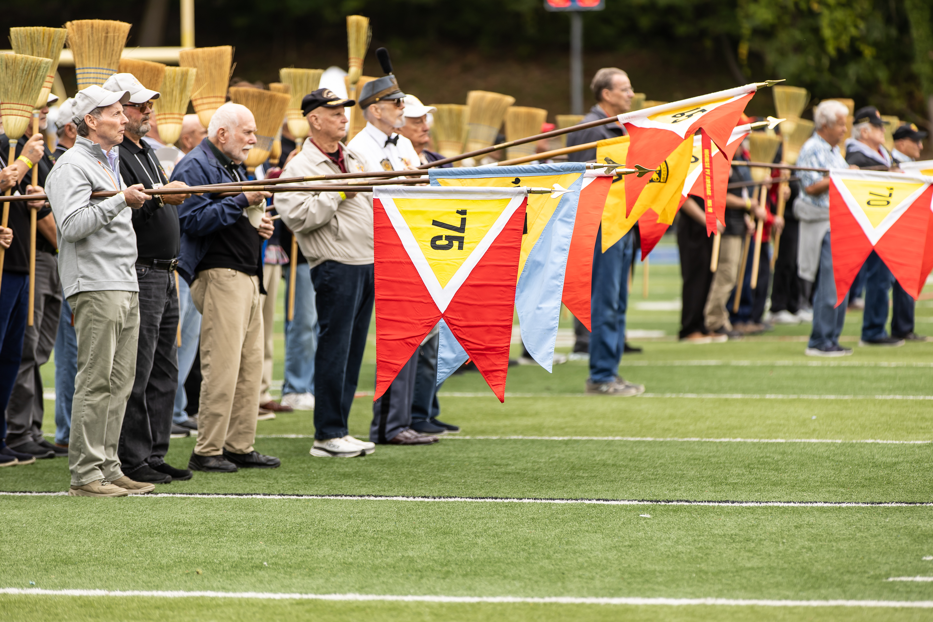 Alumni present the flags during the broom drill.